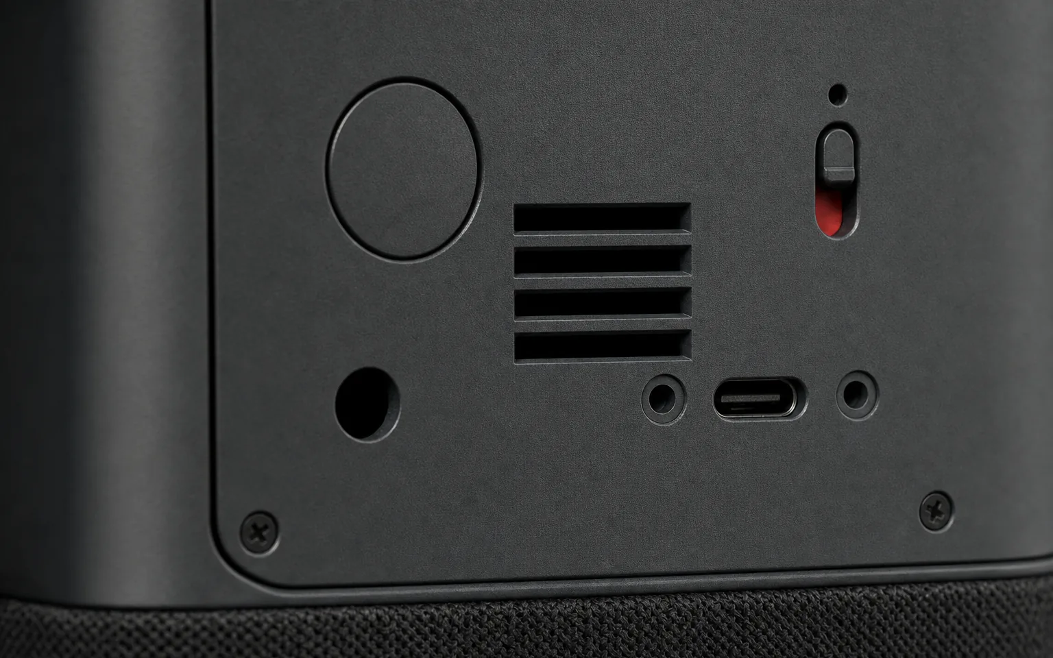Close-up of Station’s rear panel, with the microphone switch set to red beside the USB-C socket.